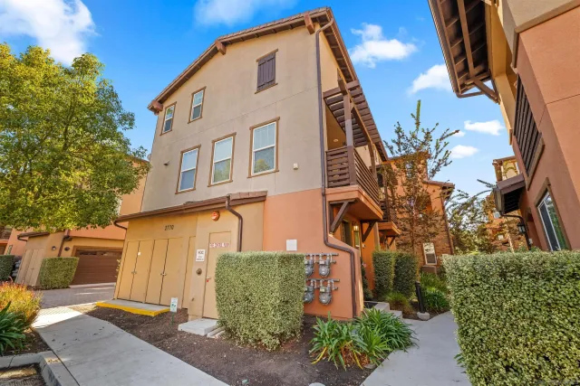 a view of a house with swimming pool and sitting area