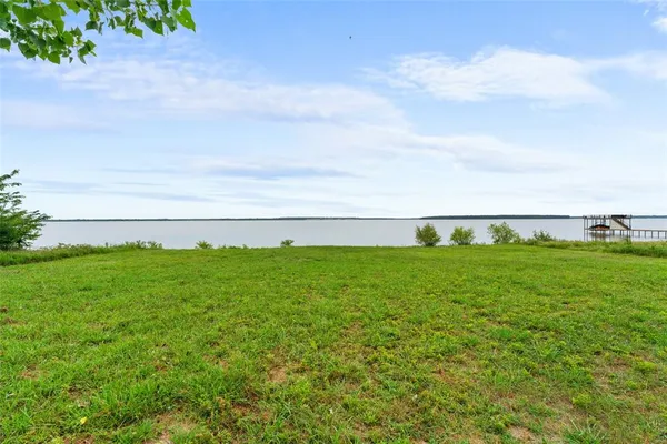a view of a big yard with large trees