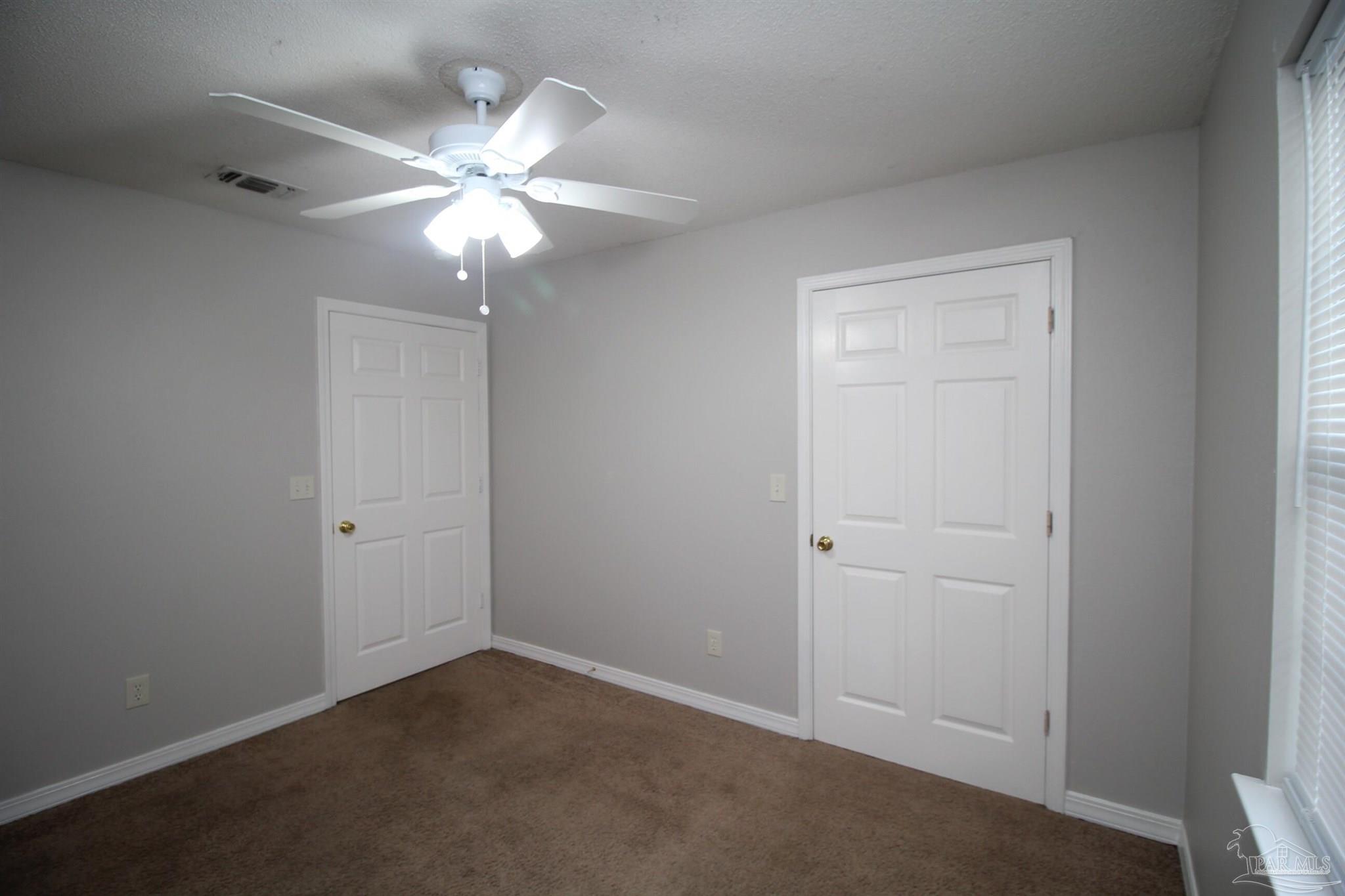 7135 Pearson Road, Unit 7 Pensacola, FL 32526 - Photo 11 of 14 an empty room with a fan and a fan