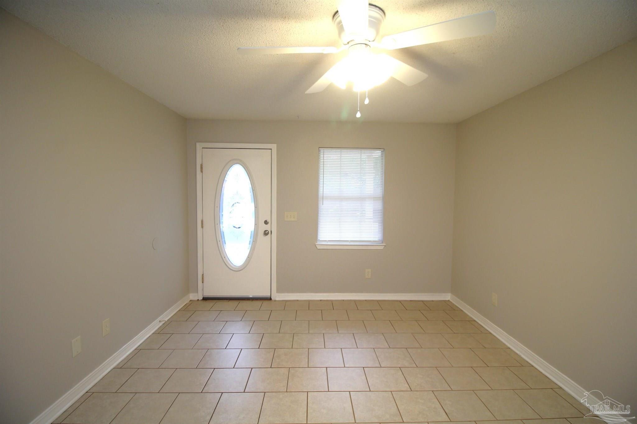 7135 Pearson Road, Unit 7 Pensacola, FL 32526 - Photo 3 of 14 an empty room with windows and fan
