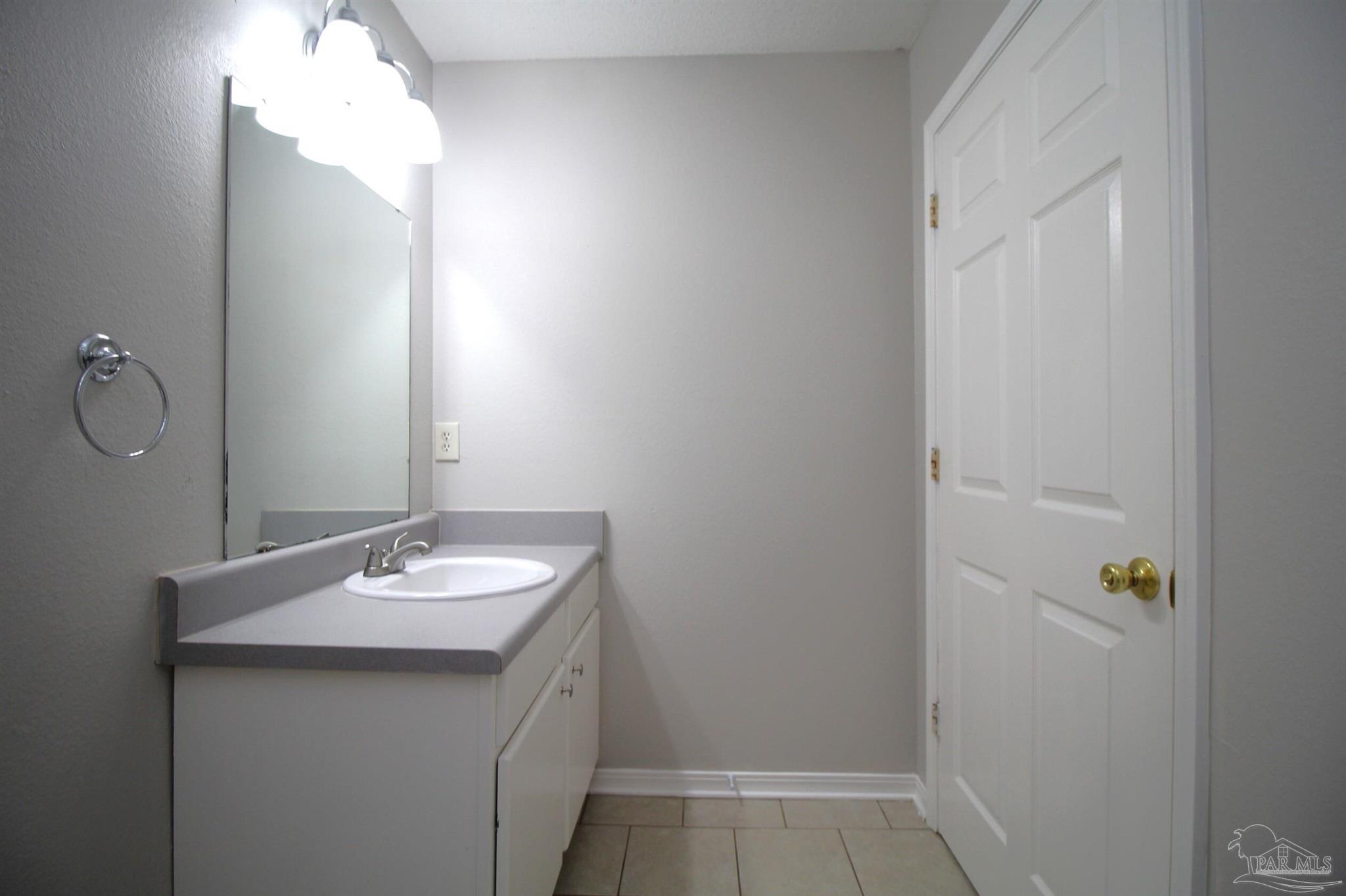 7135 Pearson Road, Unit 7 Pensacola, FL 32526 - Photo 10 of 14 a bathroom with a sink and a mirror