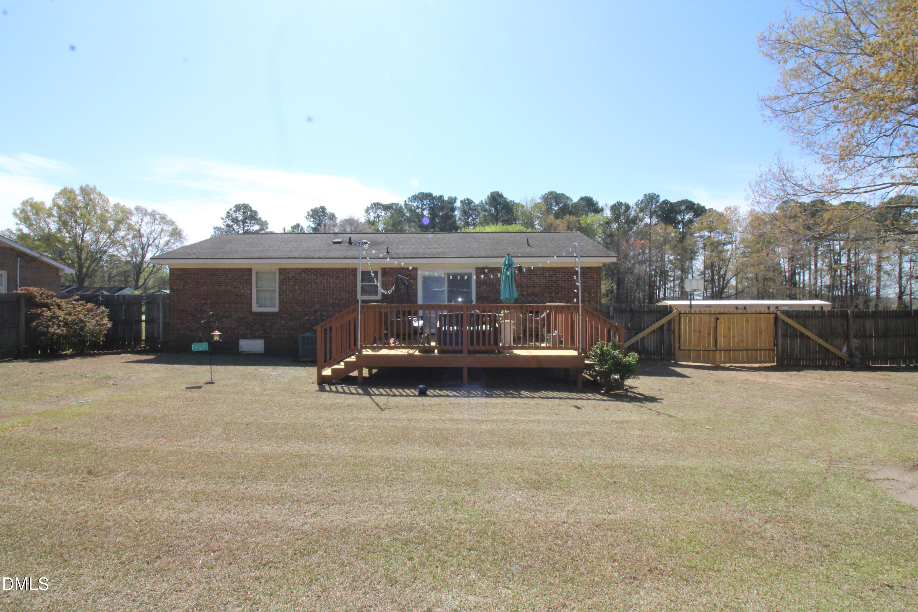 56 Ash Street Coats, NC 27521 - Photo 6 of 28 a view of a house with a backyard and a car parked in it