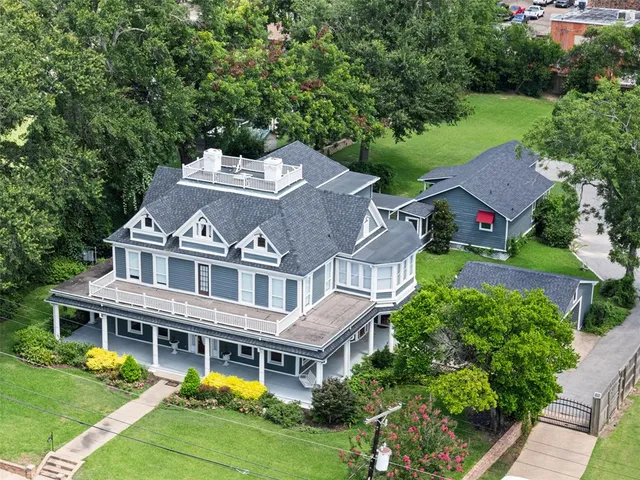 an aerial view of residential houses with yard and swimming pool