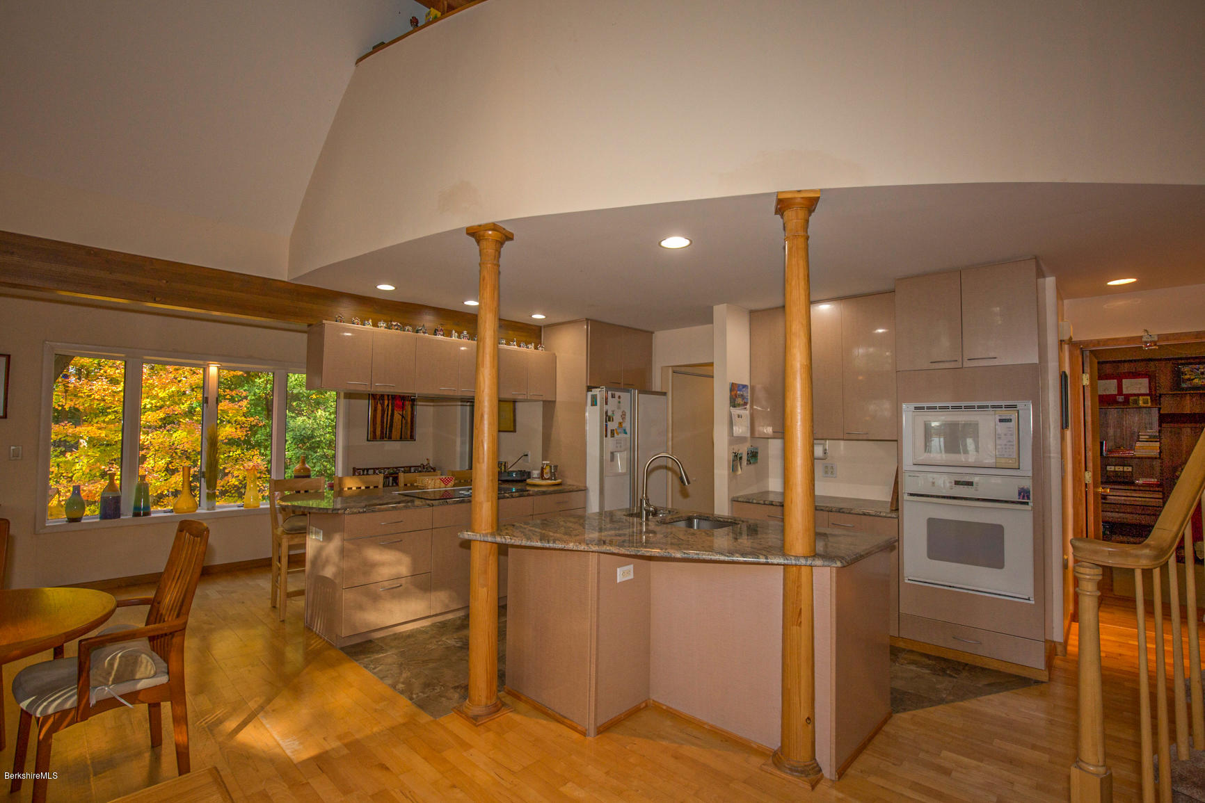 57 Golden Hill Road Lee, MA 01238 - Photo 9 of 43 a kitchen with stainless steel appliances kitchen island granite countertop a refrigerator and cabinets