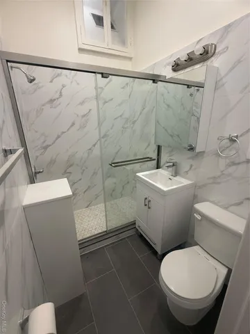 a white toilet sitting next to a bathroom sink
