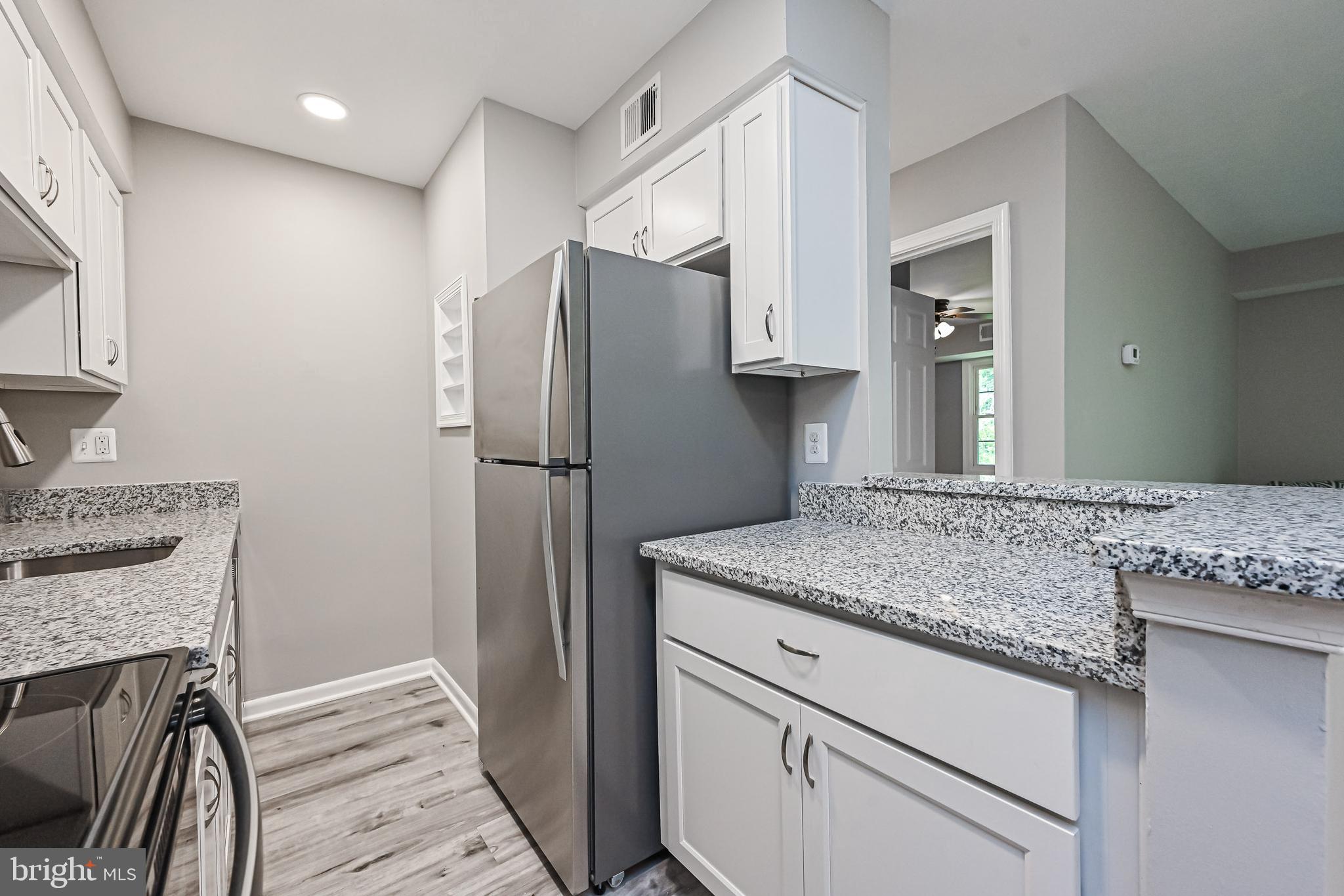 8110 Colony Point Road, Unit 216 Springfield, VA 22152 - Photo 12 of 28 Renovated kitchen w/granite & LVP flooring