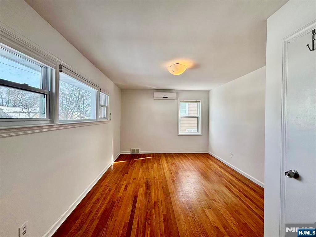 62 Howland Avenue Teaneck, NJ 07666 - Photo 12 of 31 a view of a room with wooden floor and window