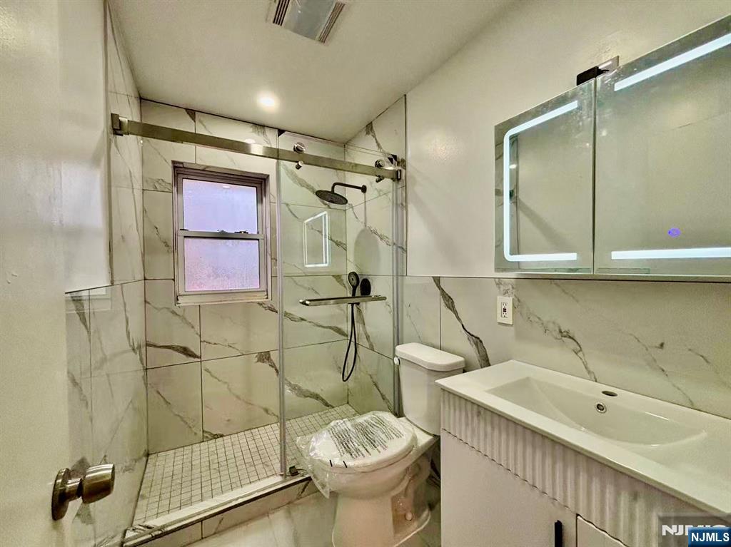 62 Howland Avenue Teaneck, NJ 07666 - Photo 16 of 31 a bathroom with a sink toilet and shower