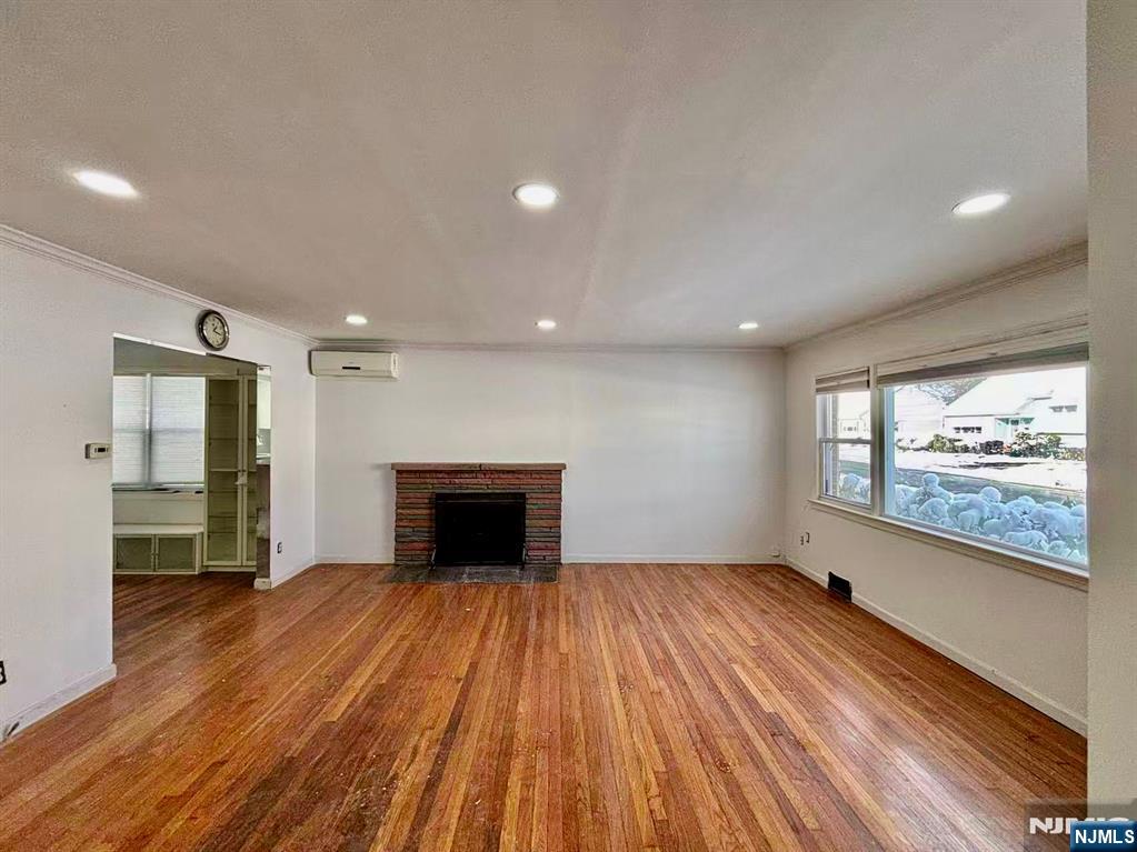 62 Howland Avenue Teaneck, NJ 07666 - Photo 3 of 31 a view of empty room with wooden floor and a window