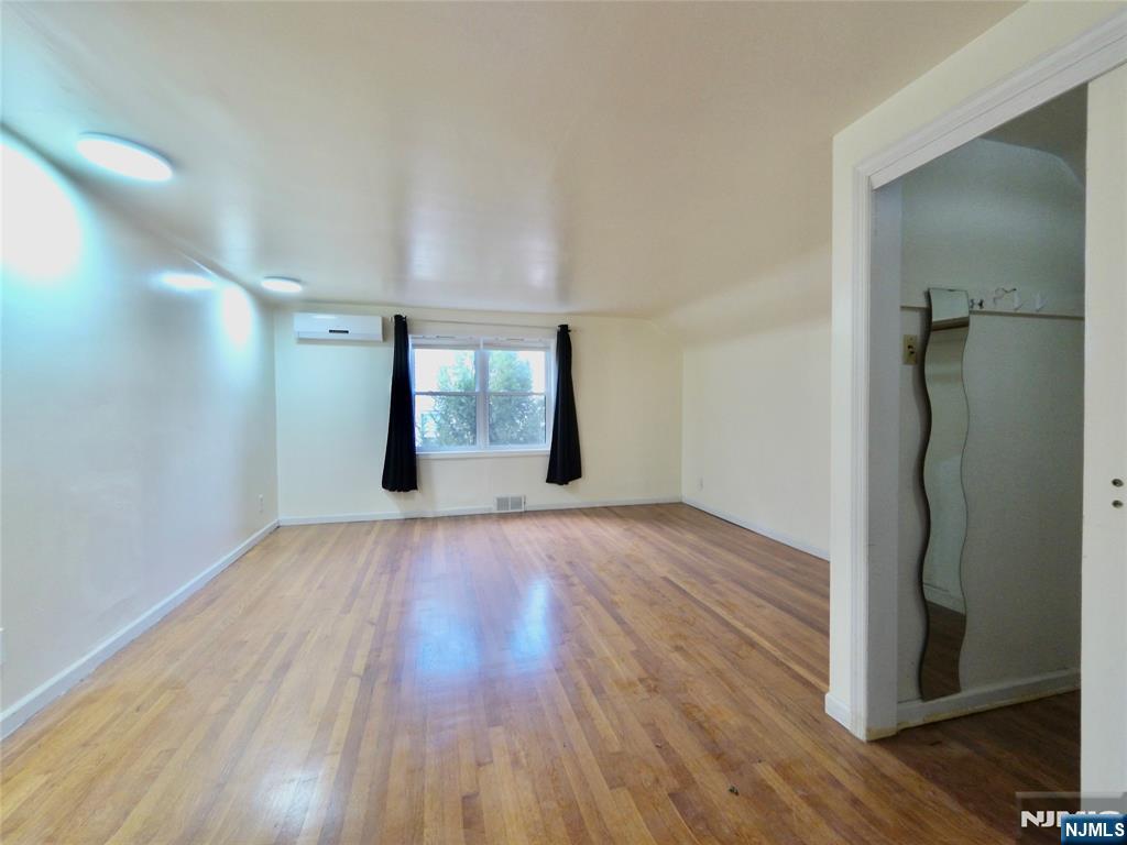 62 Howland Avenue Teaneck, NJ 07666 - Photo 8 of 31 wooden floor in an empty room with a window