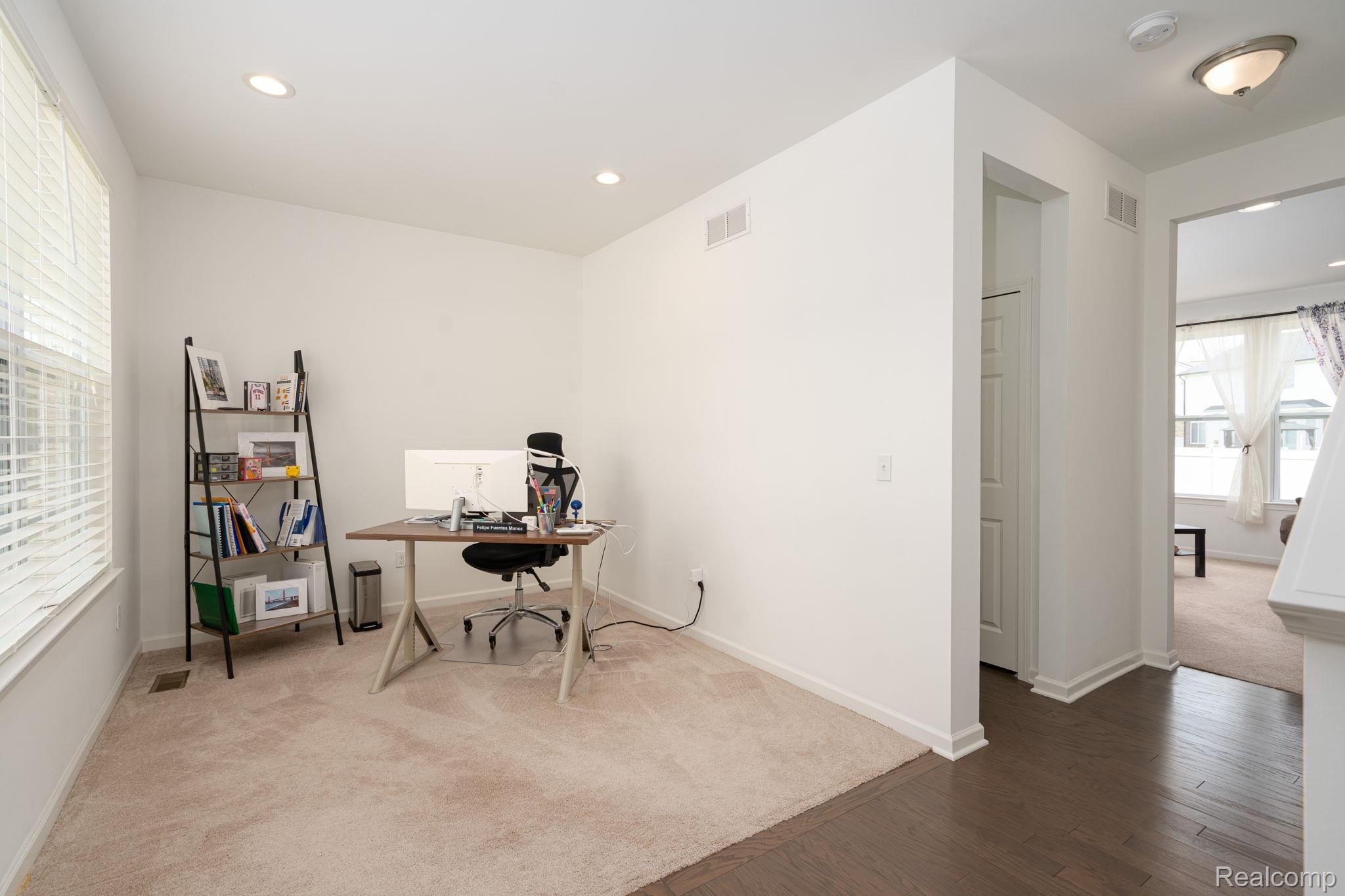 48904 Carnegie Way Macomb, MI 48042 - Photo 16 of 34 Carpeted flex space featuring a large window with blinds, recessed lighting, and white walls
