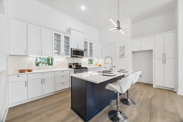 a kitchen with sink cabinets and wooden floor