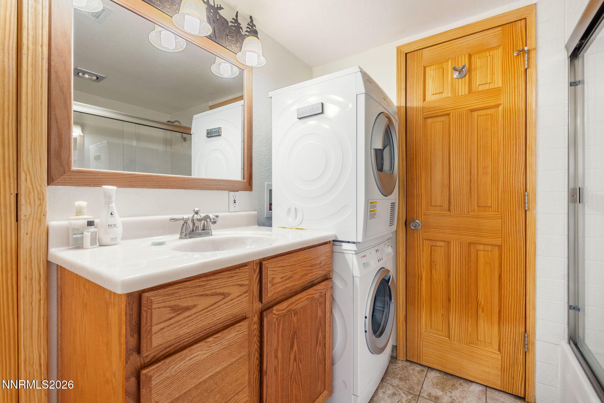 759 Boulder Court, Unit F Stateline, NV 89449 - Photo 22 of 36 a bathroom with a sink a vanity and a mirror