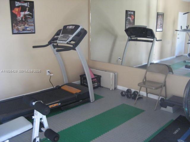 9044 Southwest 112th Court Miami, FL 33176 - Photo 18 of 19 a room with gym equipment and a view of living room