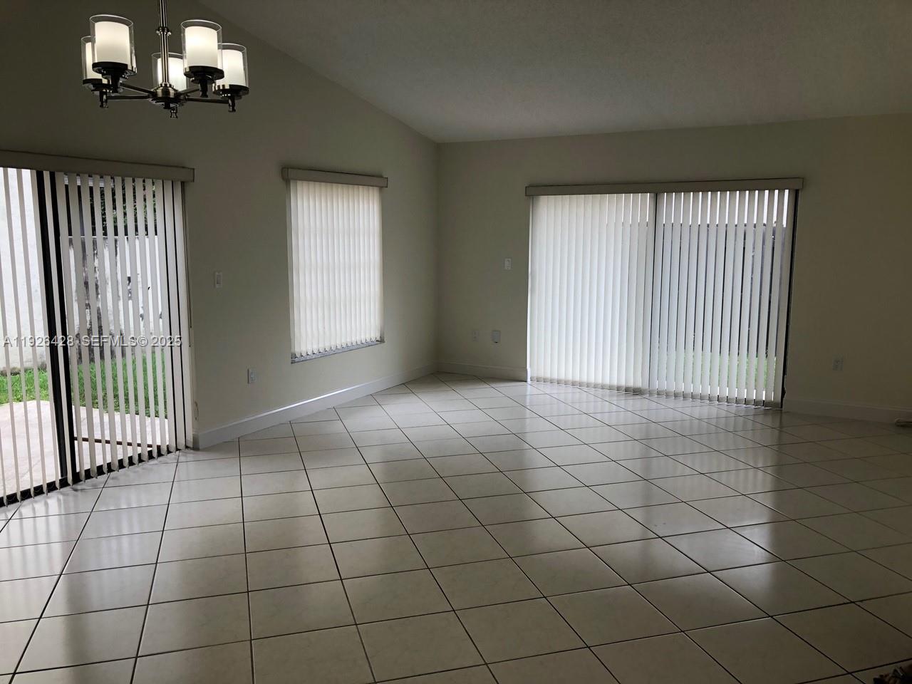 9044 Southwest 112th Court Miami, FL 33176 - Photo 2 of 19 a view of an empty room with a window