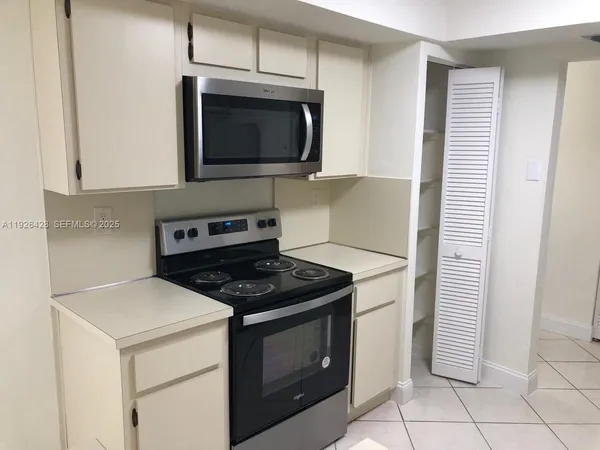 a kitchen with a stove and a microwave