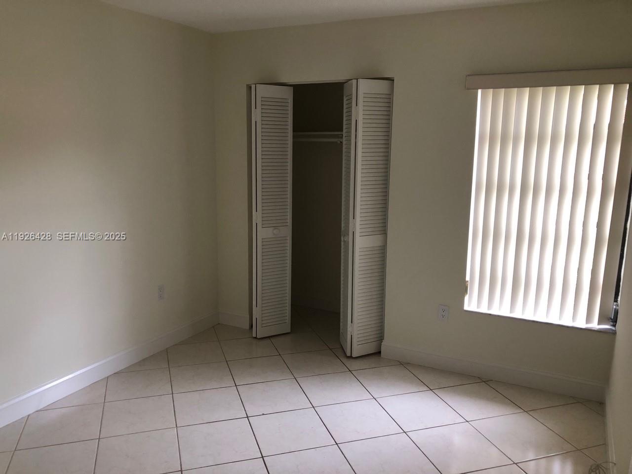9044 Southwest 112th Court Miami, FL 33176 - Photo 7 of 19 an empty room with windows