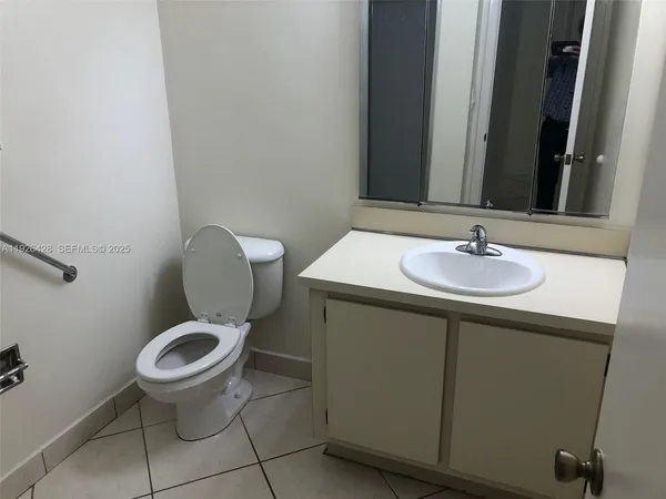 a bathroom with a sink toilet and a mirror