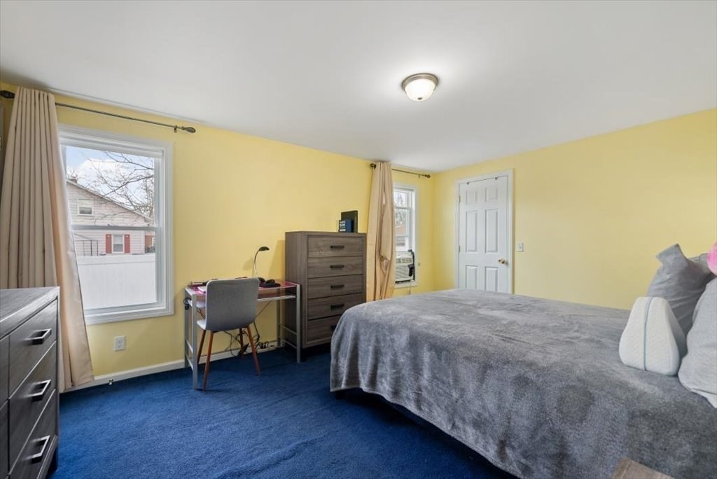 105 Geneva Street Springfield, MA 01151 - Photo 15 of 39 a bedroom with a bed and wooden floor