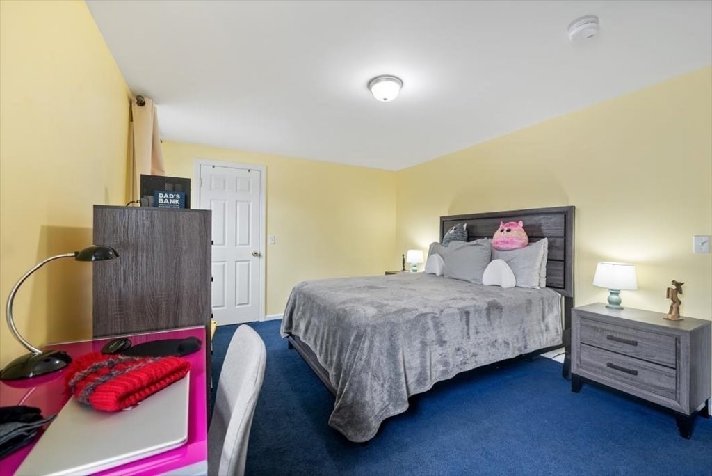 105 Geneva Street Springfield, MA 01151 - Photo 16 of 39 a bedroom with a bed and wooden floor