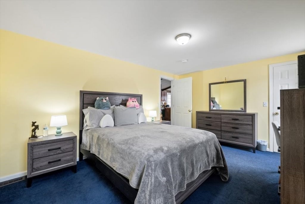 105 Geneva Street Springfield, MA 01151 - Photo 17 of 39 a bedroom with a bed and wooden floor