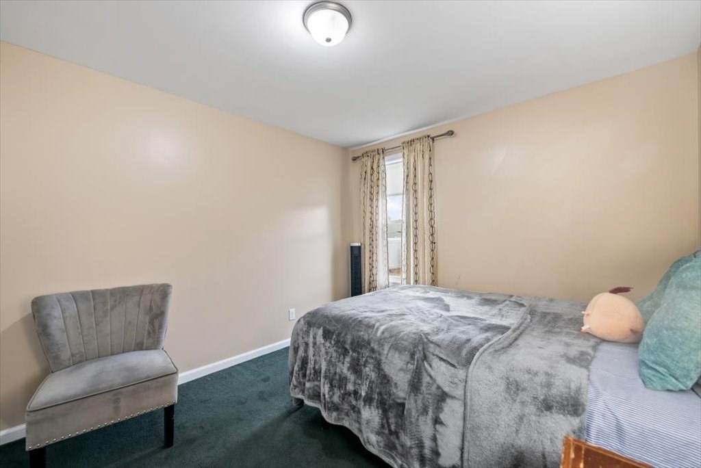 105 Geneva Street Springfield, MA 01151 - Photo 18 of 39 a bedroom with a bed and window