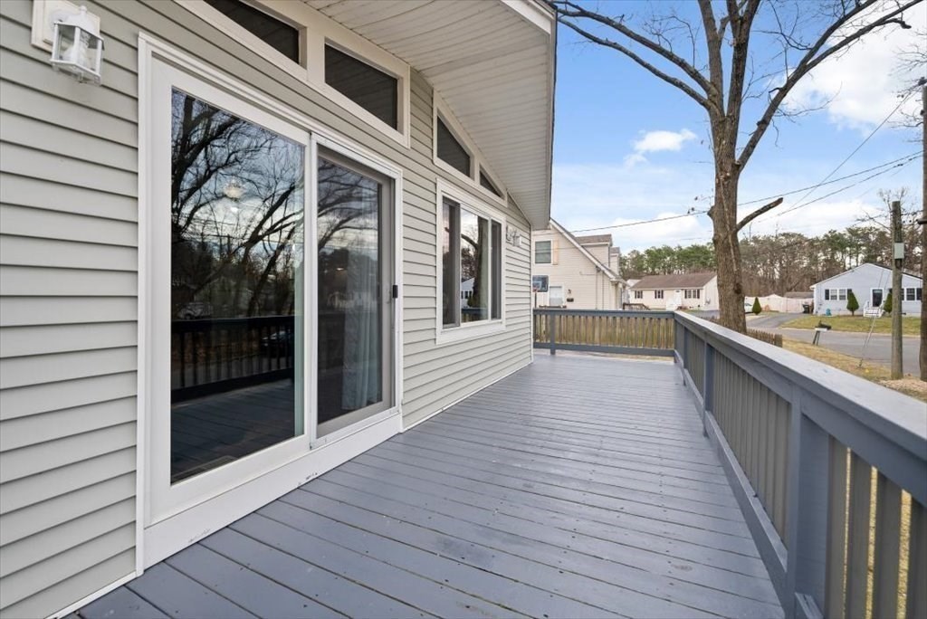 105 Geneva Street Springfield, MA 01151 - Photo 24 of 39 a view of a balcony with wooden floor and fence and a floor to ceiling window