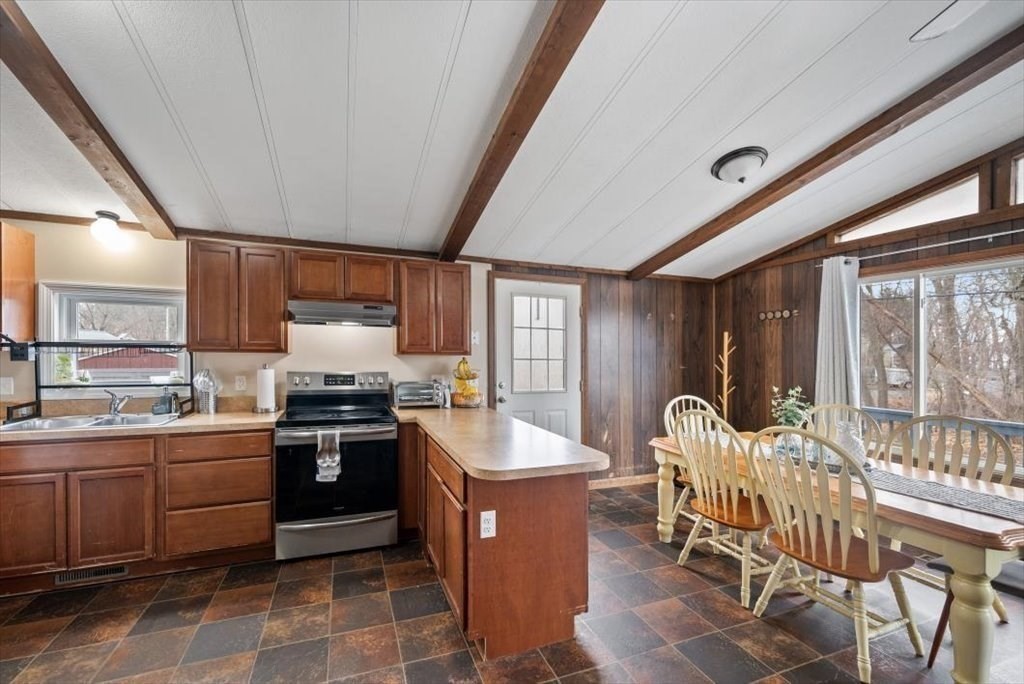 105 Geneva Street Springfield, MA 01151 - Photo 6 of 39 a kitchen with table chairs sink and cabinets