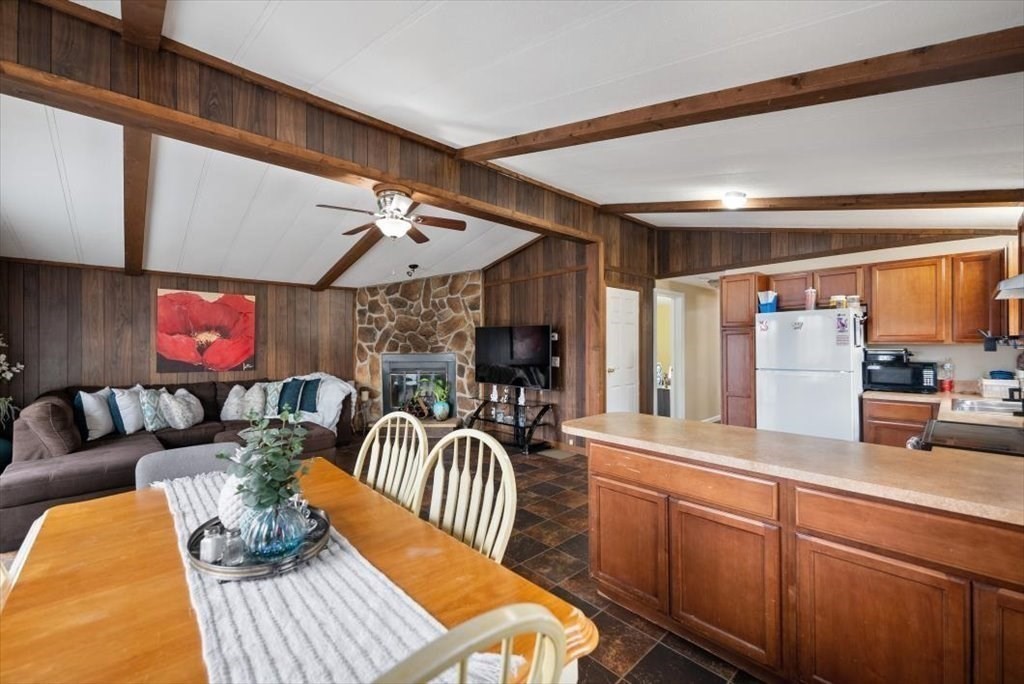 105 Geneva Street Springfield, MA 01151 - Photo 9 of 39 a outdoor living space with furniture a fireplace and a flat screen tv