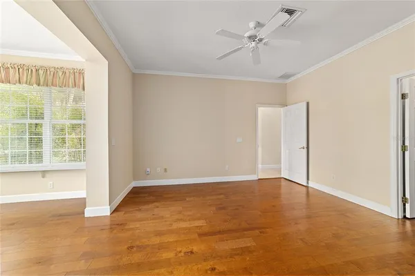 a spacious bedroom with a bed a fireplace and a large window