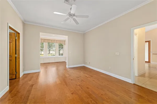 a view of a livingroom with wooden floor and a fireplace