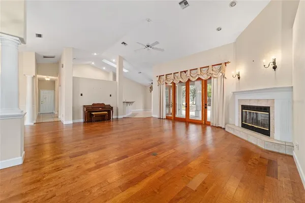 a view of an empty room with a fireplace and a window