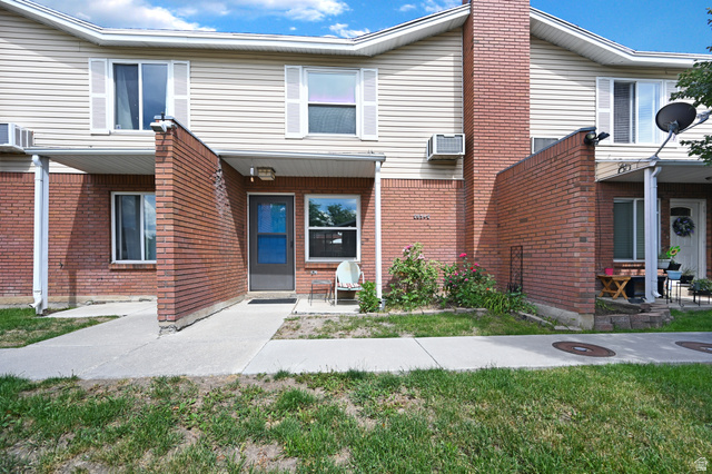 285 West 600 North, Unit 2 Logan, UT 84321 - Photo 1 of 21 Townhome exterior featuring tan horizontal siding and red brick accents