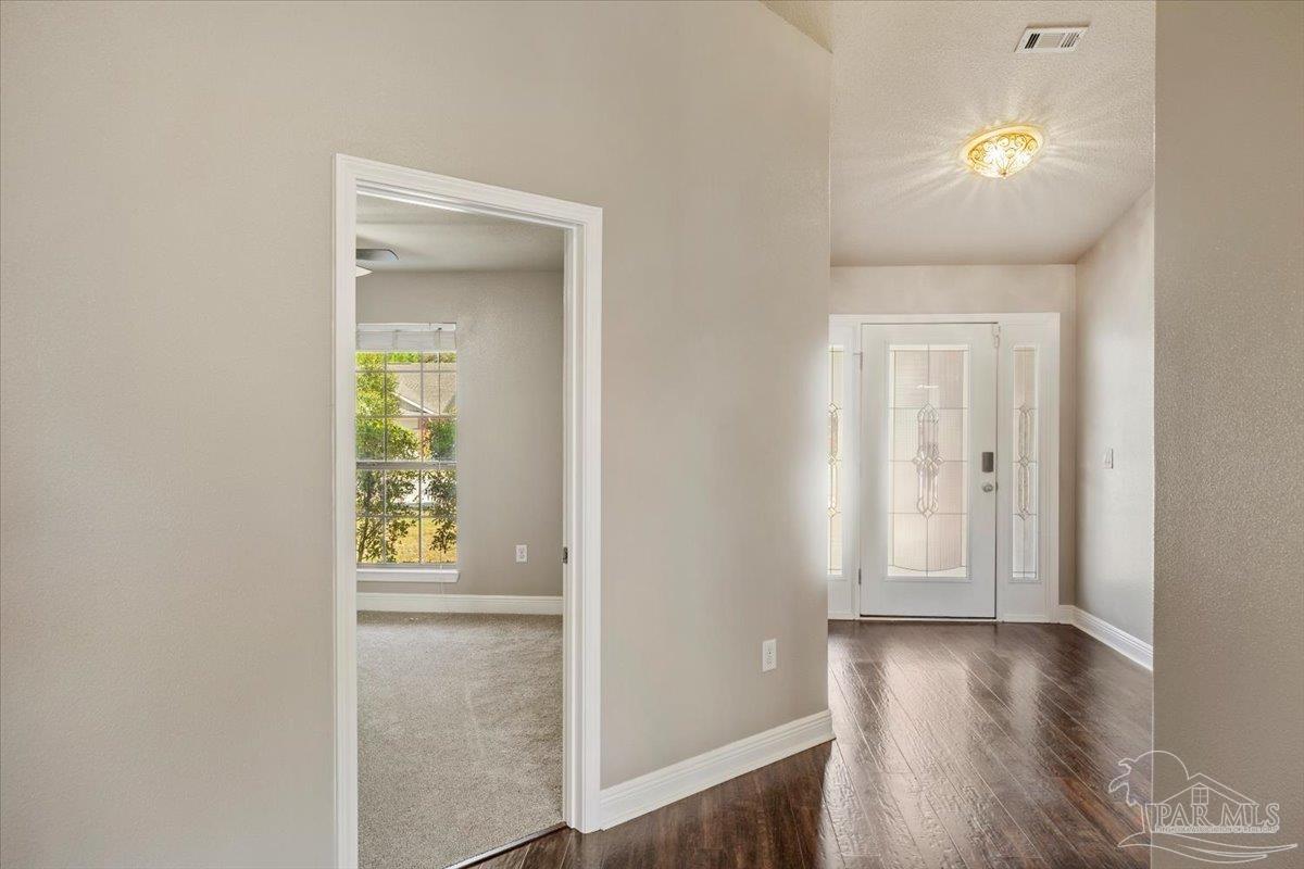 4015 Berry Circle Pace, FL 32571 - Photo 6 of 48 a view of an entryway with wooden floor