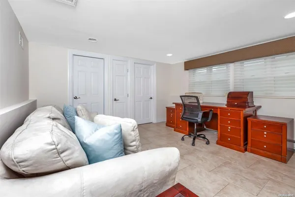 a bedroom with a bed and a flat tv screen on a dresser