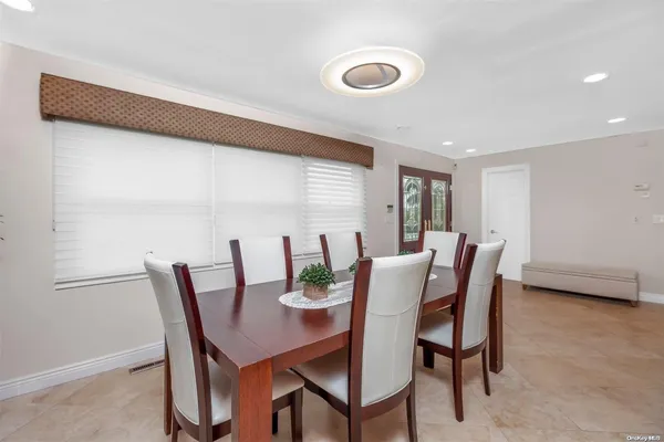 a view of a dining room with furniture and window