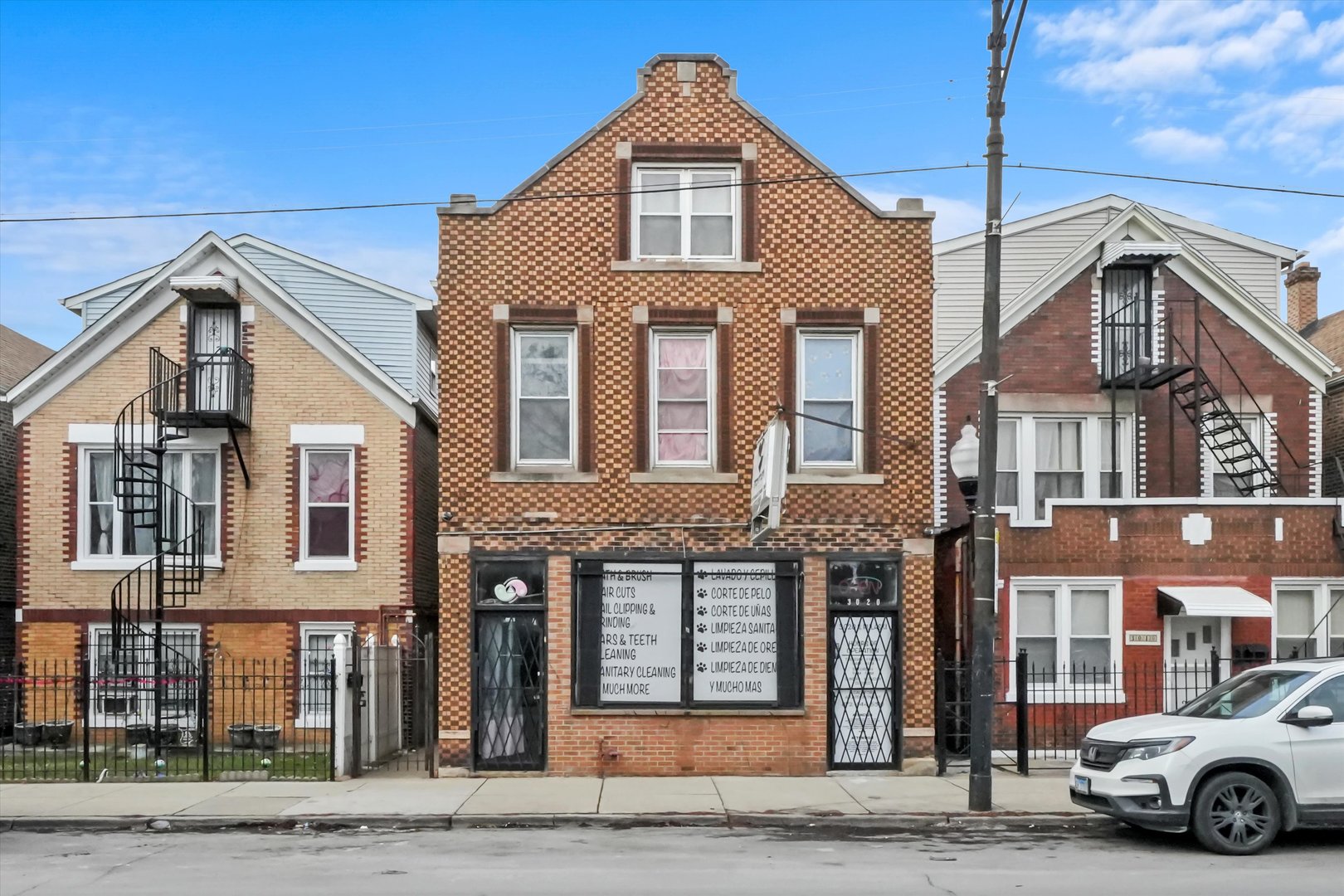 3020 South Pulaski Road Chicago, IL 60623 - Photo 1 of 44 a front view of a house with a road