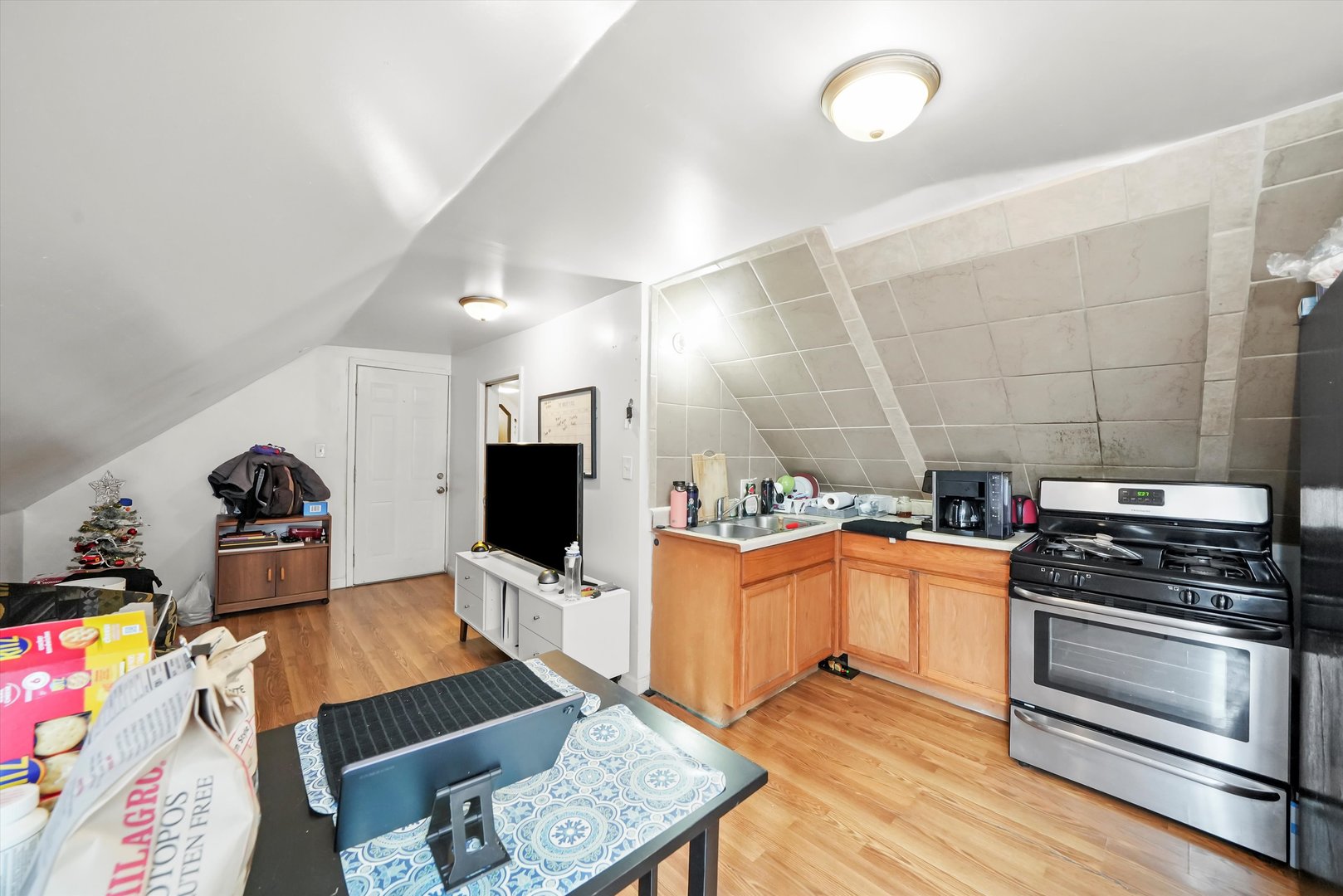 3020 South Pulaski Road Chicago, IL 60623 - Photo 27 of 44 a kitchen with stainless steel appliances a stove a sink and a refrigerator