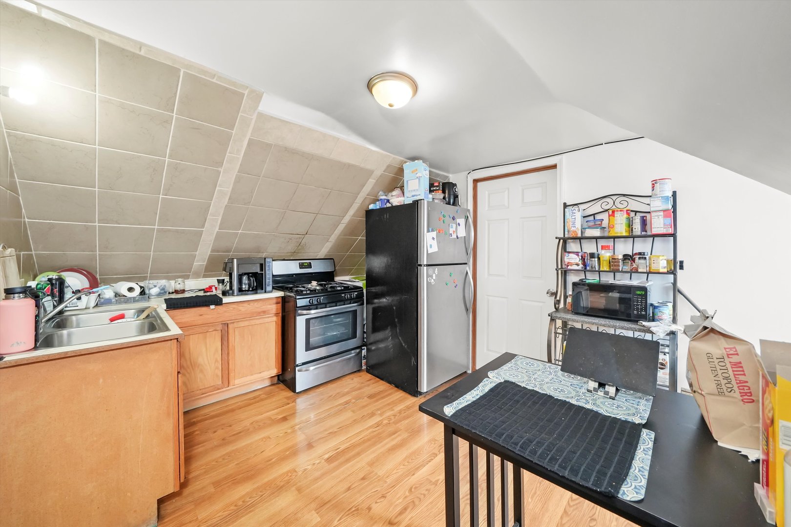3020 South Pulaski Road Chicago, IL 60623 - Photo 28 of 44 a kitchen with stainless steel appliances kitchen island granite countertop a refrigerator and a stove top oven