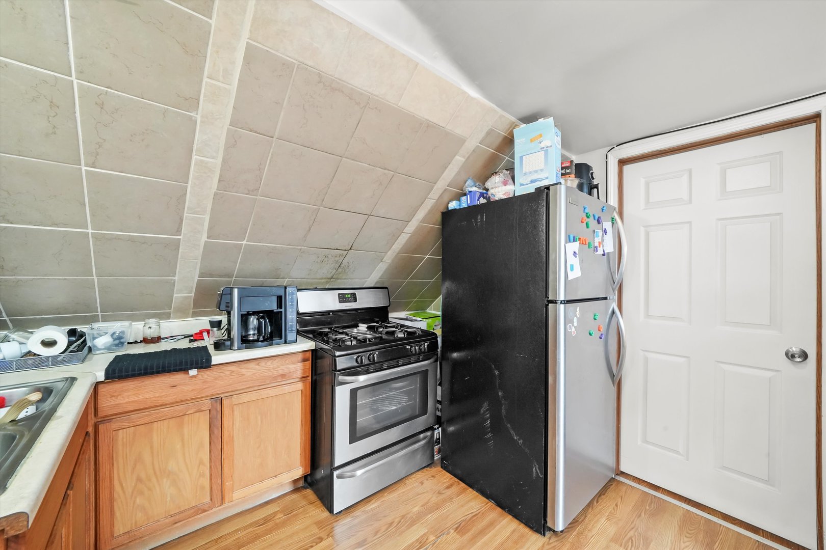 3020 South Pulaski Road Chicago, IL 60623 - Photo 29 of 44 a kitchen with a refrigerator and cabinets
