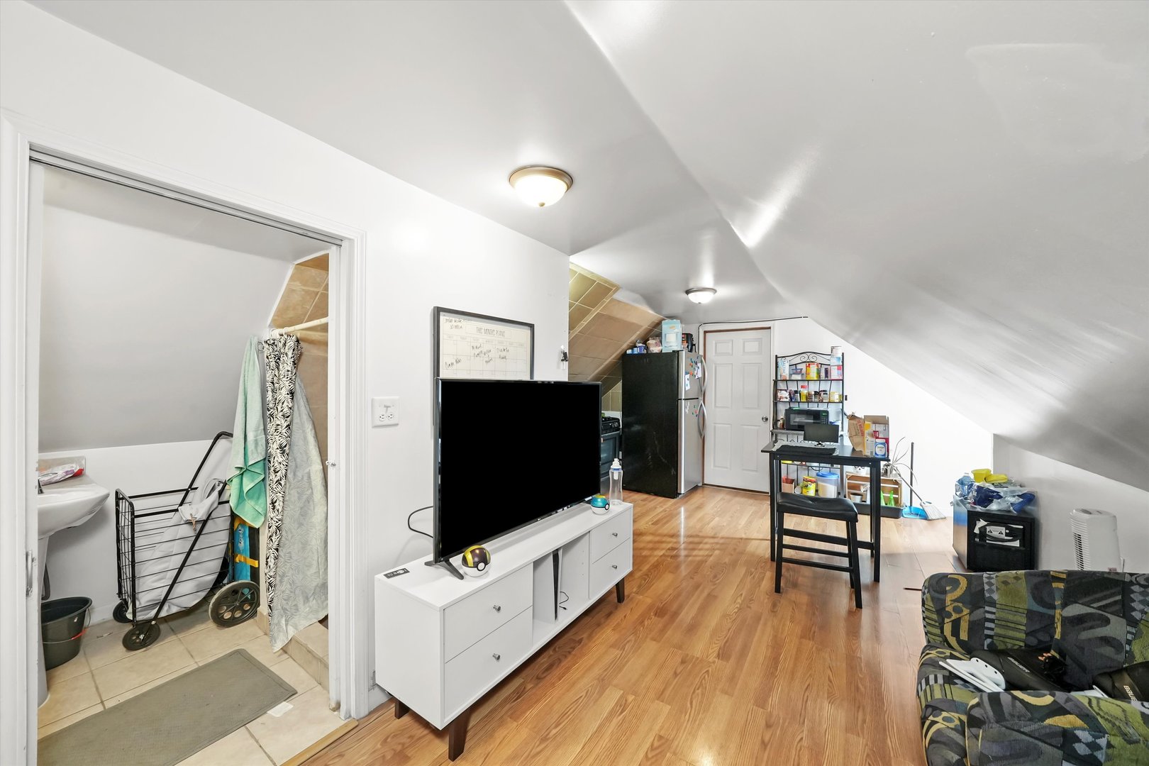 3020 South Pulaski Road Chicago, IL 60623 - Photo 33 of 44 a living room with furniture and a flat screen tv