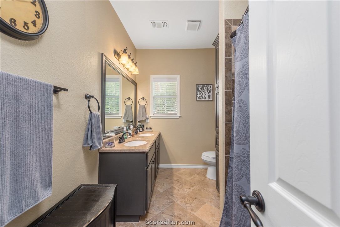 112 Rebecca Street Bryan, TX 77801 - Photo 11 of 18 a bathroom with a sink toilet and a mirror