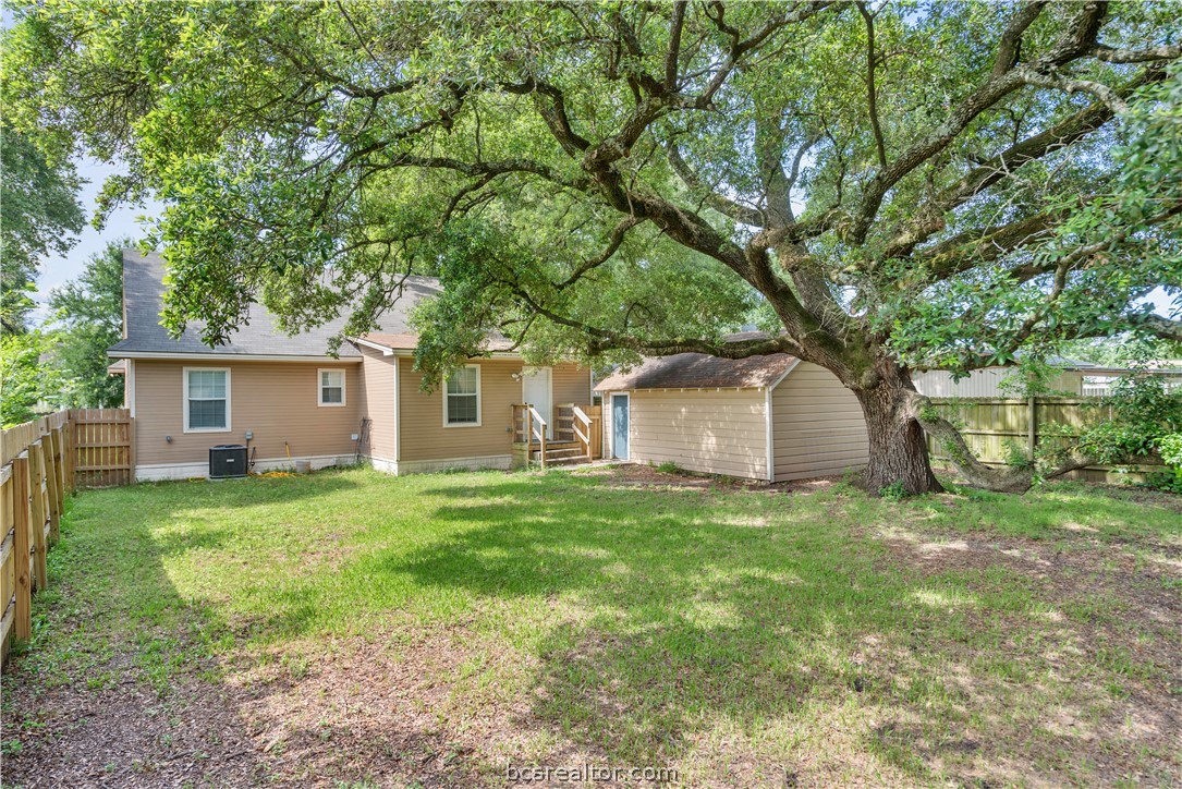112 Rebecca Street Bryan, TX 77801 - Photo 15 of 18 a yellow house in middle of the forest
