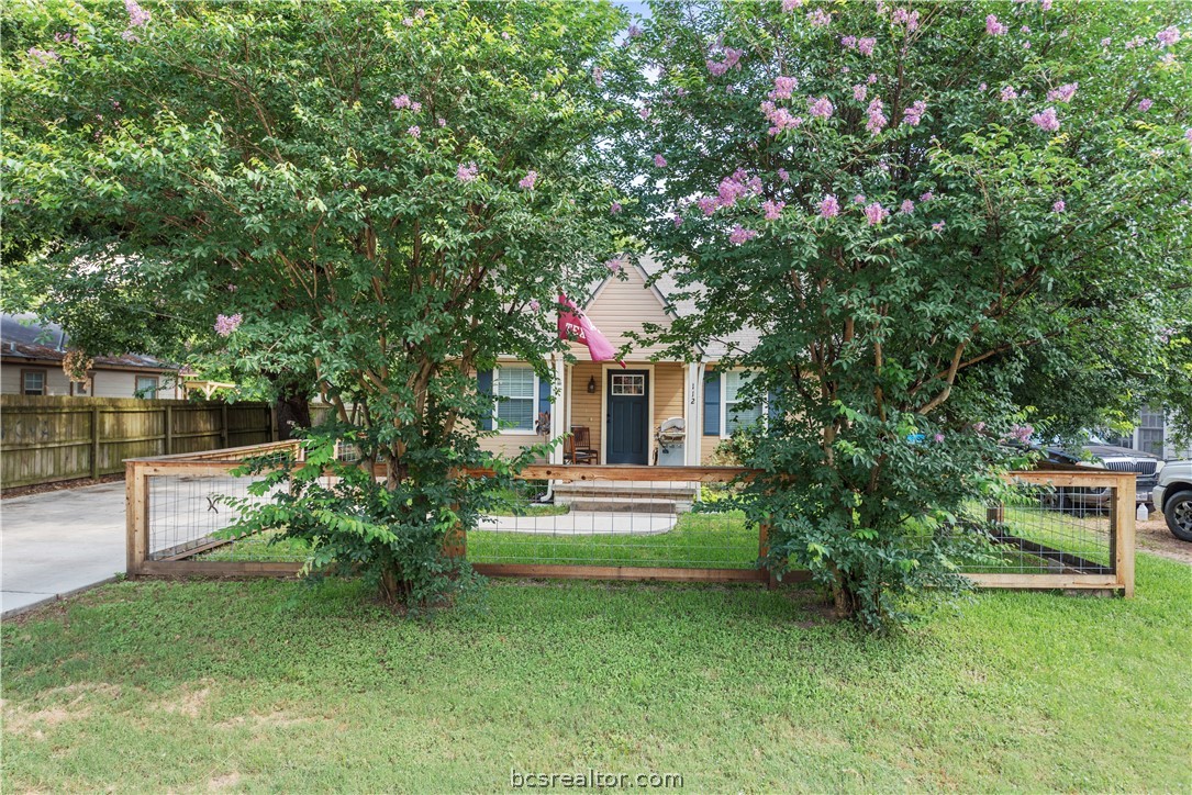 112 Rebecca Street Bryan, TX 77801 - Photo 18 of 18 a front view of a house with a yard and tree
