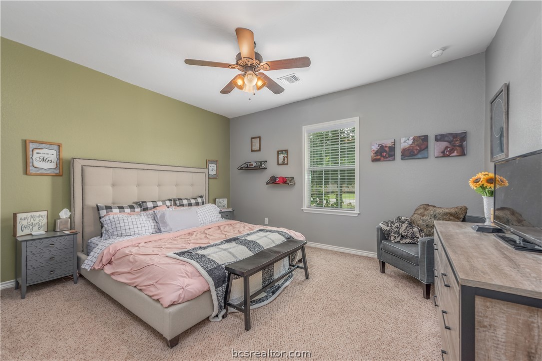 112 Rebecca Street Bryan, TX 77801 - Photo 9 of 18 a bedroom with a bed and a chandelier