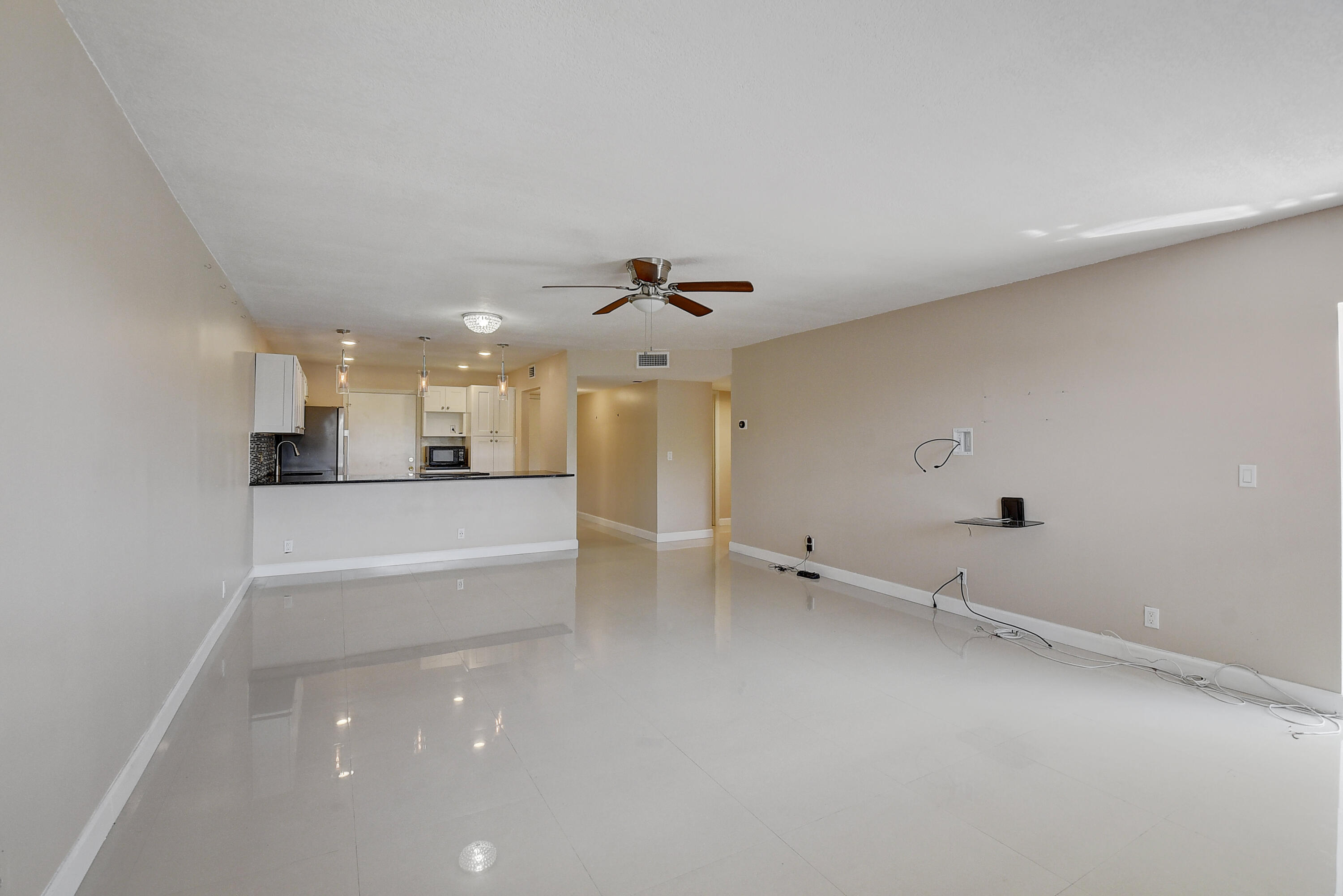 22605 Southwest 66th Avenue, Unit 304 Boca Raton, FL 33428 - Photo 7 of 25 Living room looking into kitchen