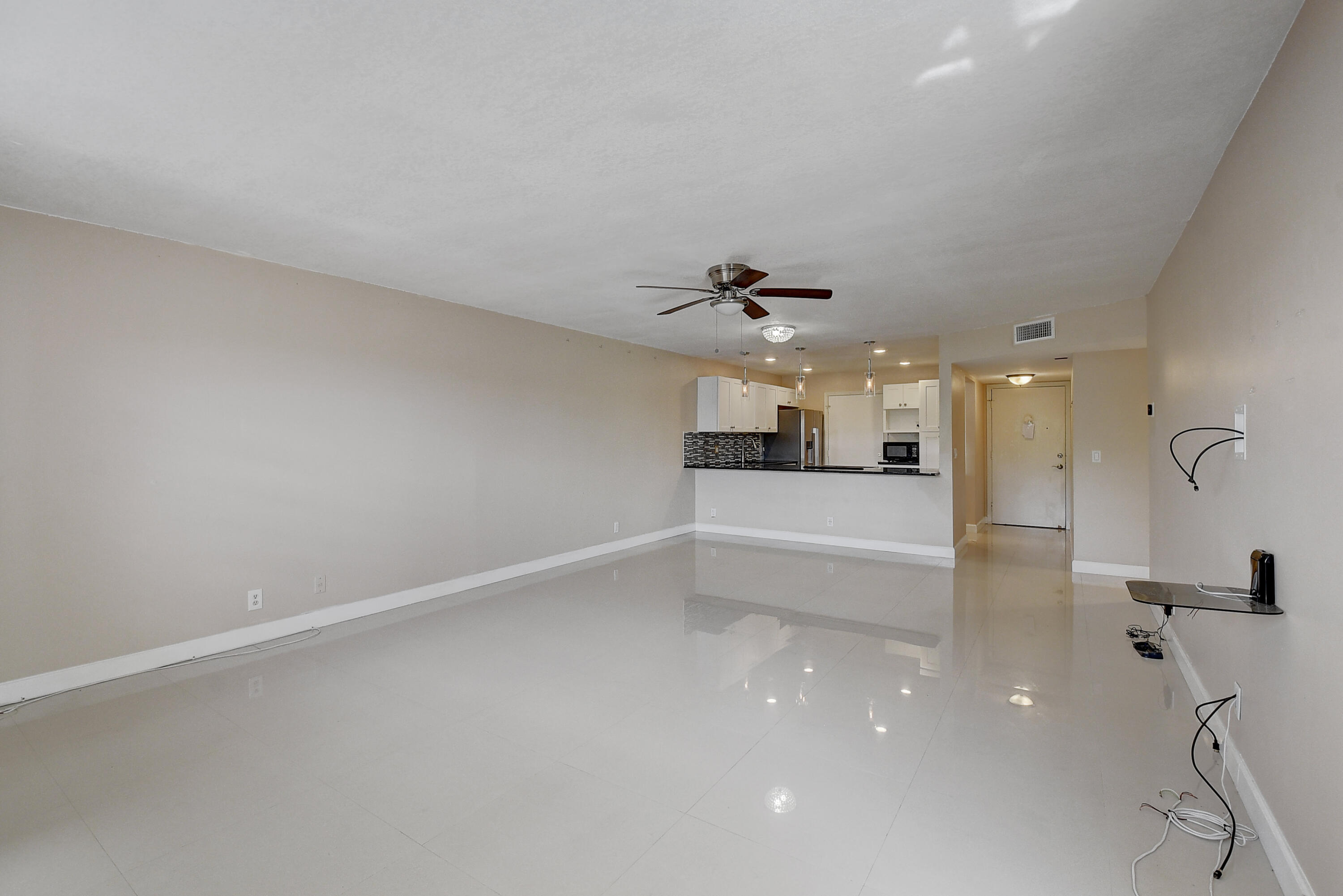 22605 Southwest 66th Avenue, Unit 304 Boca Raton, FL 33428 - Photo 8 of 25 Living room looking into kitchen