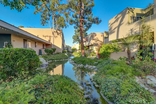 a view of a house with a yard and fountain