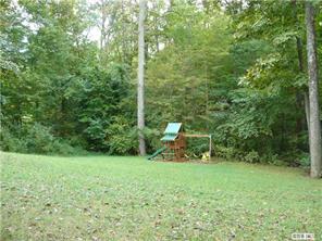 8009 Larkhaven Road Charlotte, NC 28216 - Photo 2 of 16 a view of a bench in a garden