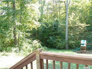 8009 Larkhaven Road Charlotte, NC 28216 - Photo 13 of 16 a balcony with trees in front of it